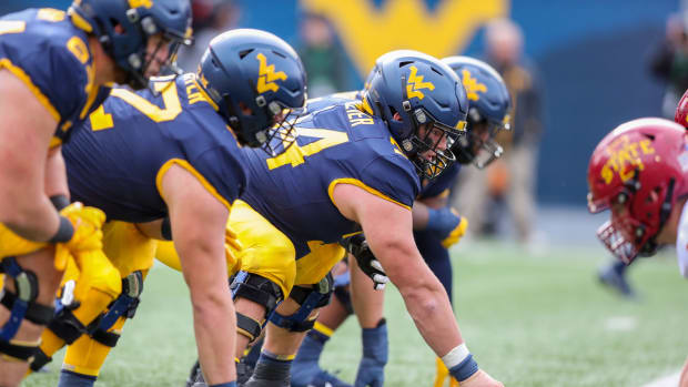 Oct 30, 2021; Morgantown, West Virginia, USA; West Virginia Mountaineers offensive lineman Zach Frazier (54) over center before a snap during the second quarter against the Iowa State Cyclones at Mountaineer Field at Milan Puskar Stadium.